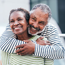 An older couple hugging. Link to Gifts from Retirement Plans