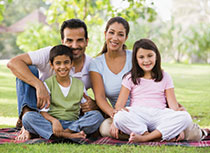 Photo of a family smiling for a picture. Link to Life Stage Gift Planner Under Age 45 Situations.